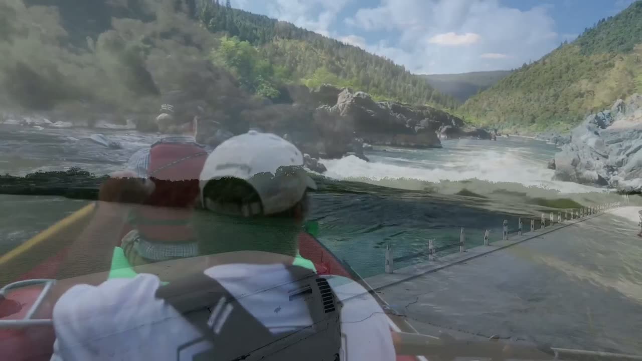 A frame in the middle of the crossfade, with the road and the camper van showing through the rafting shot as the two clips blend