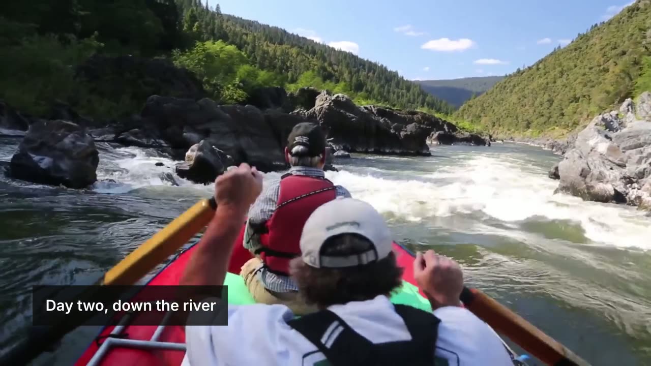 The rafting shot with a translucent dark bar in the lower left carrying the white text Day two, down the river