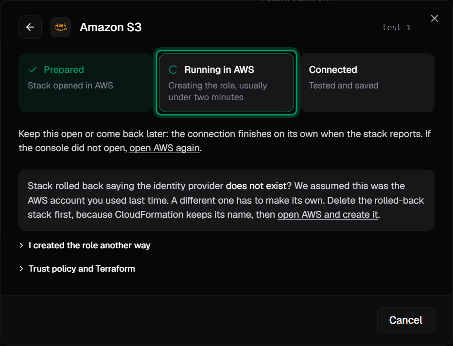 The connect dialog's progress view with three steps. Prepared, stack opened in AWS, is done. Running in AWS, creating the role, usually under two minutes, is in progress. Connected, tested and saved, is next.